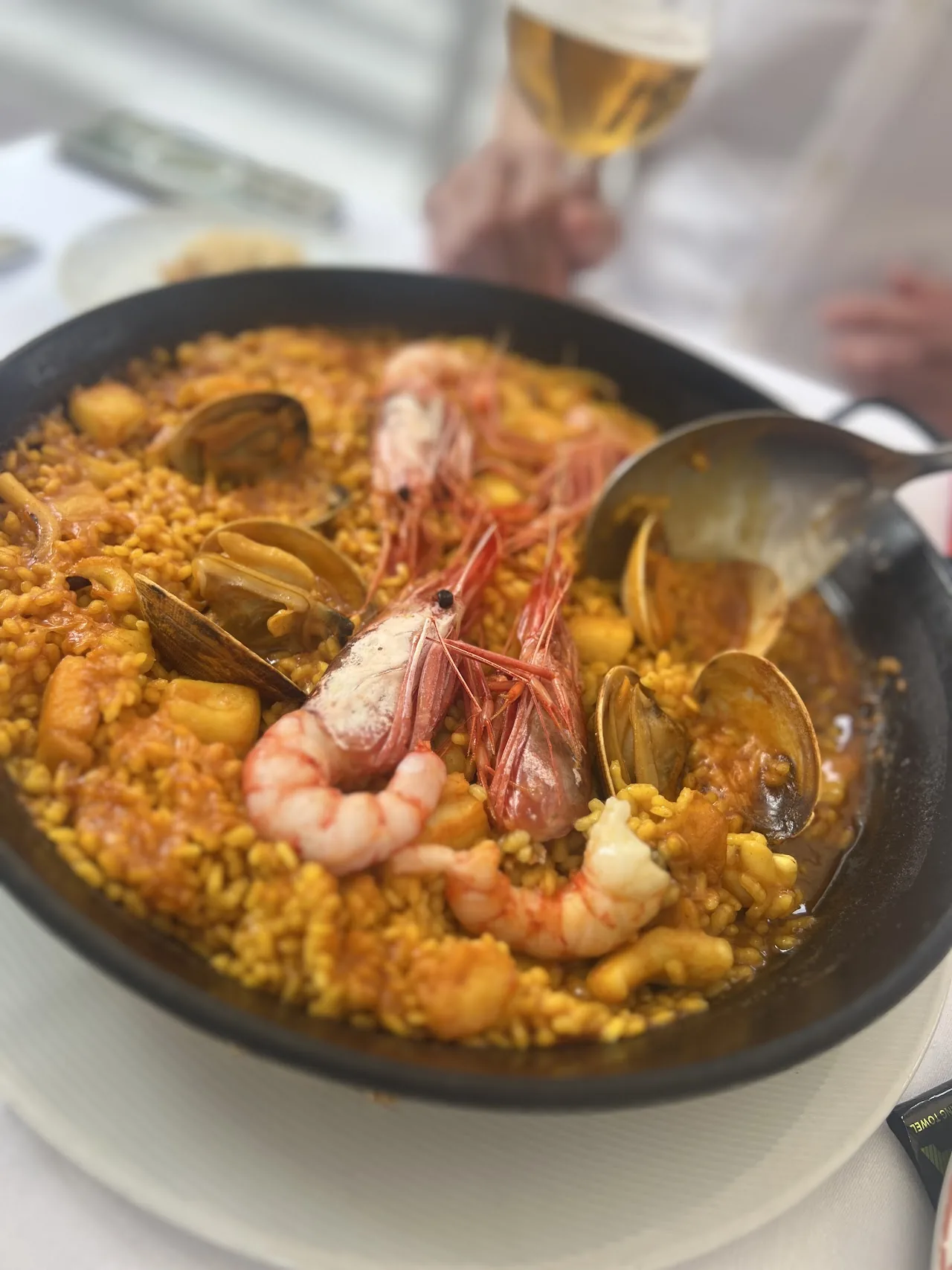 A seafood paella with shrimp, clams, and langoustine