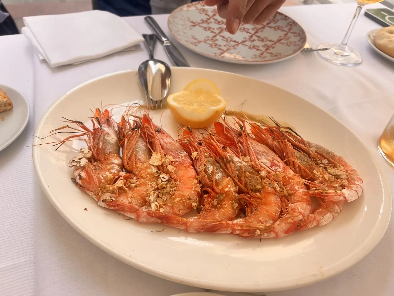 A plate of whole grilled king prawns with lemon