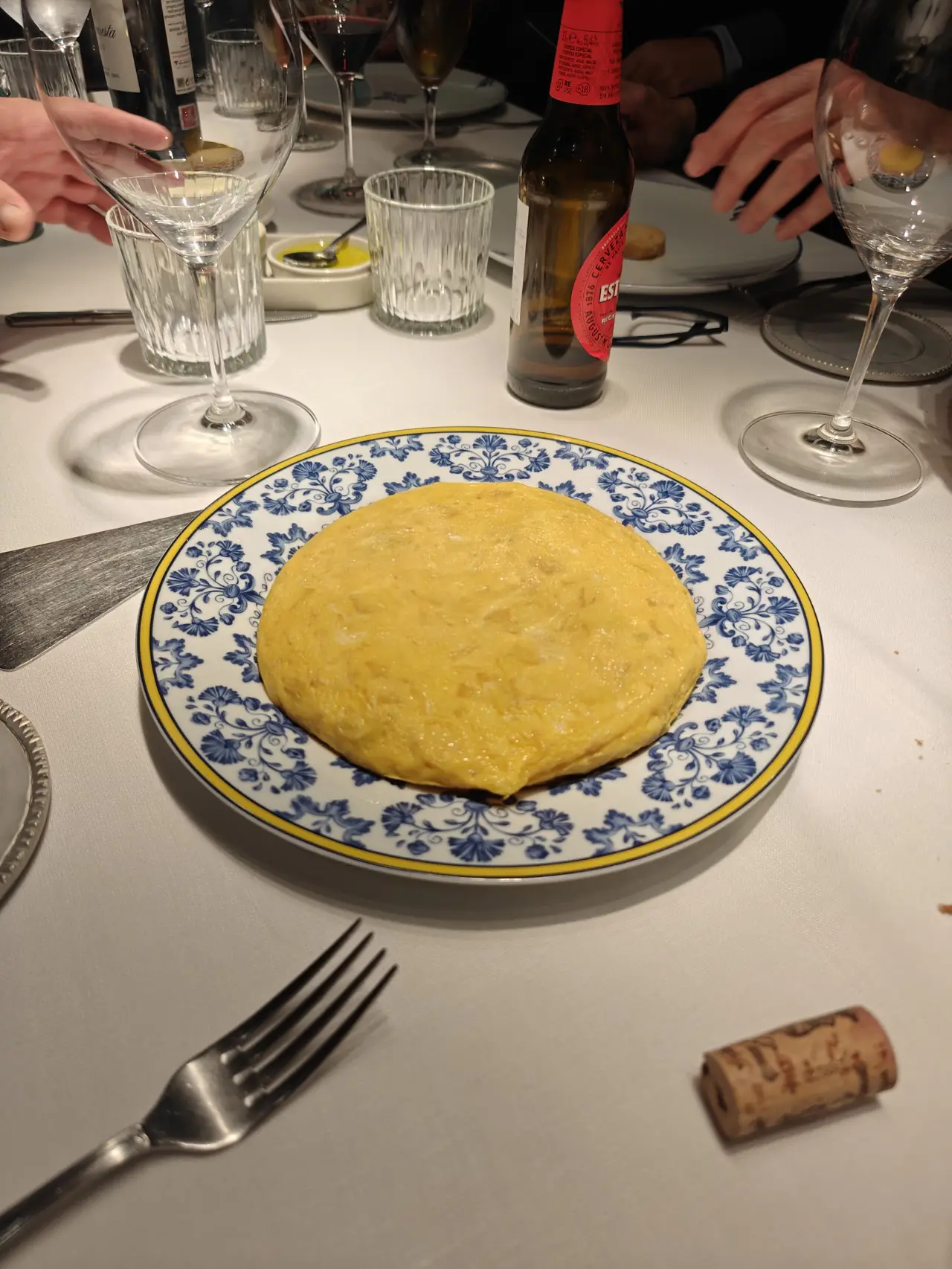 Whole round Spanish tortilla on a blue and white patterned plate