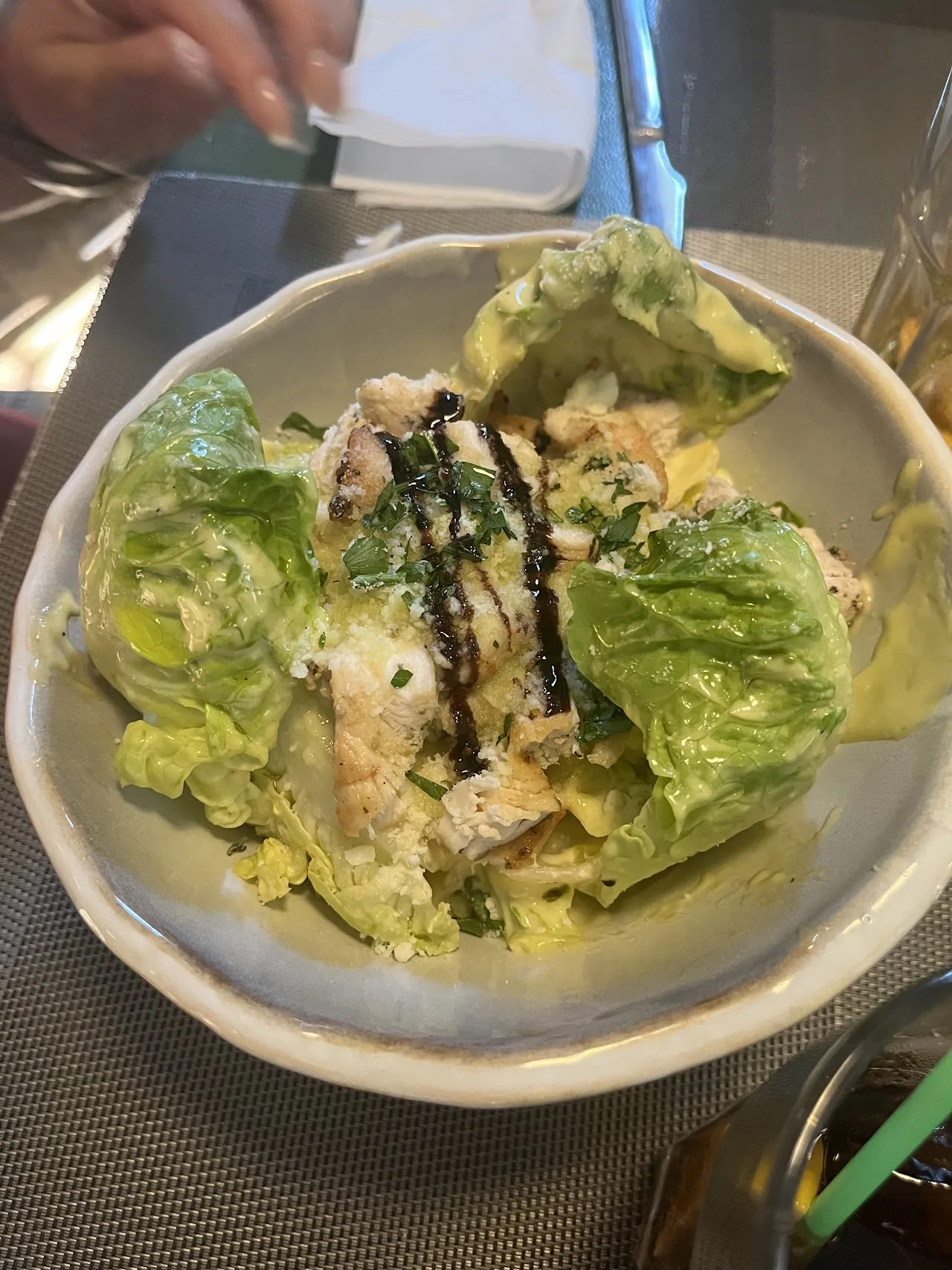 A salad of lettuce leaves with dressing and sesame seeds