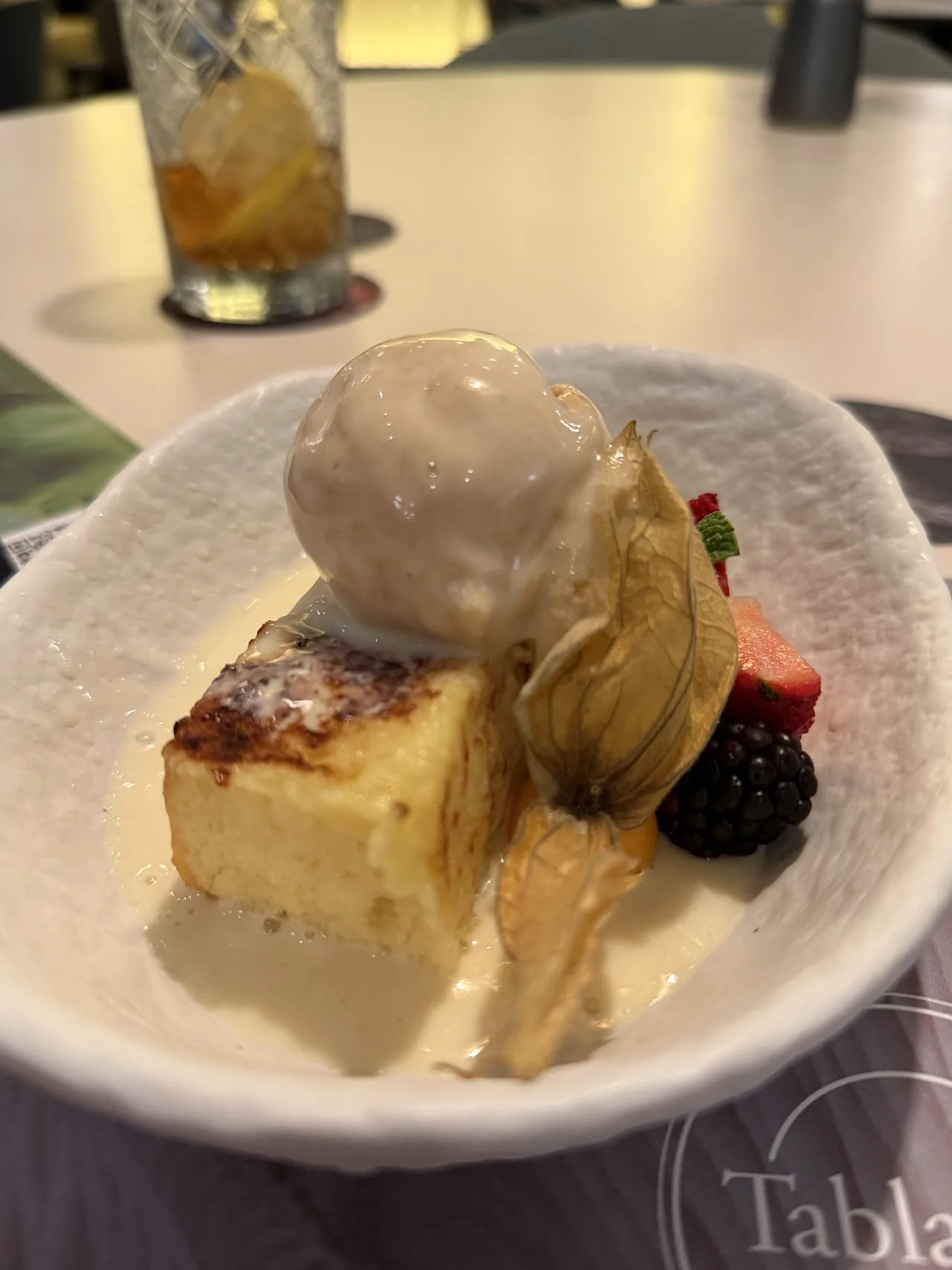 A slice of cake with ice cream and fresh berries
