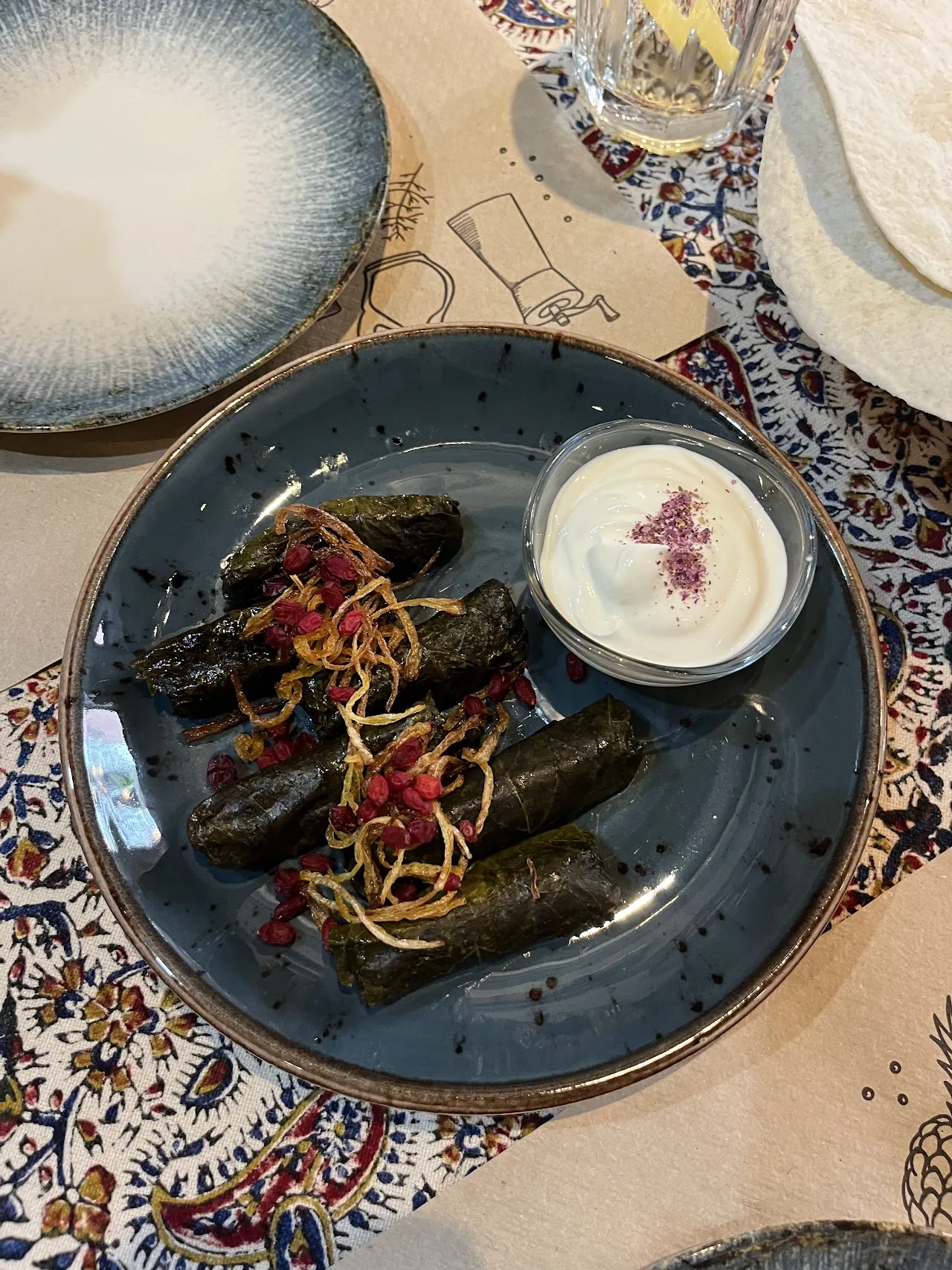 Stuffed grape leaves served with a yogurt sauce