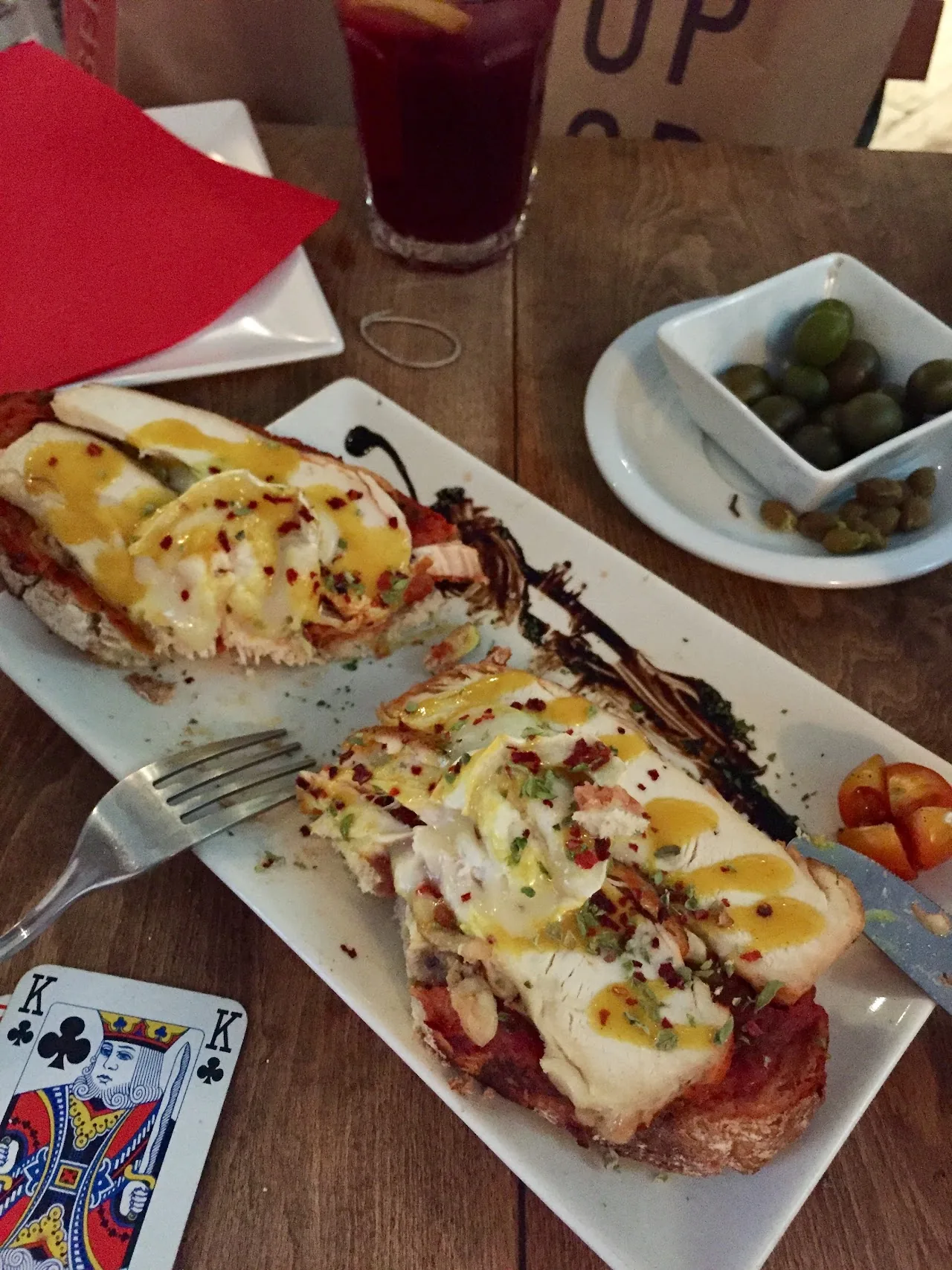 Toasted bread topped with melted cheese and cured ham