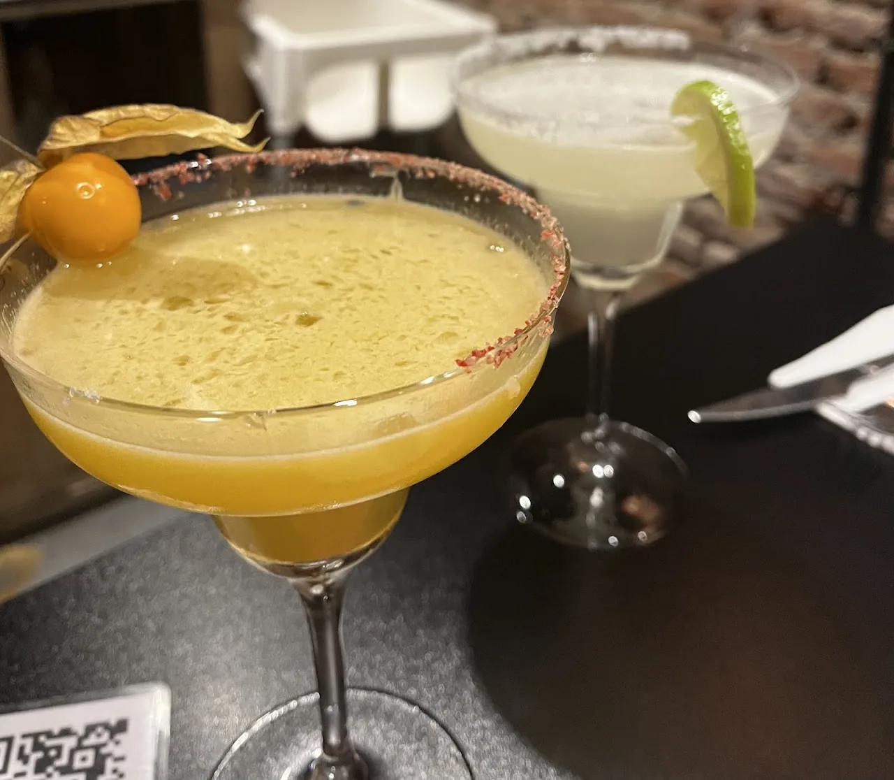 Two margarita cocktails with salted rims