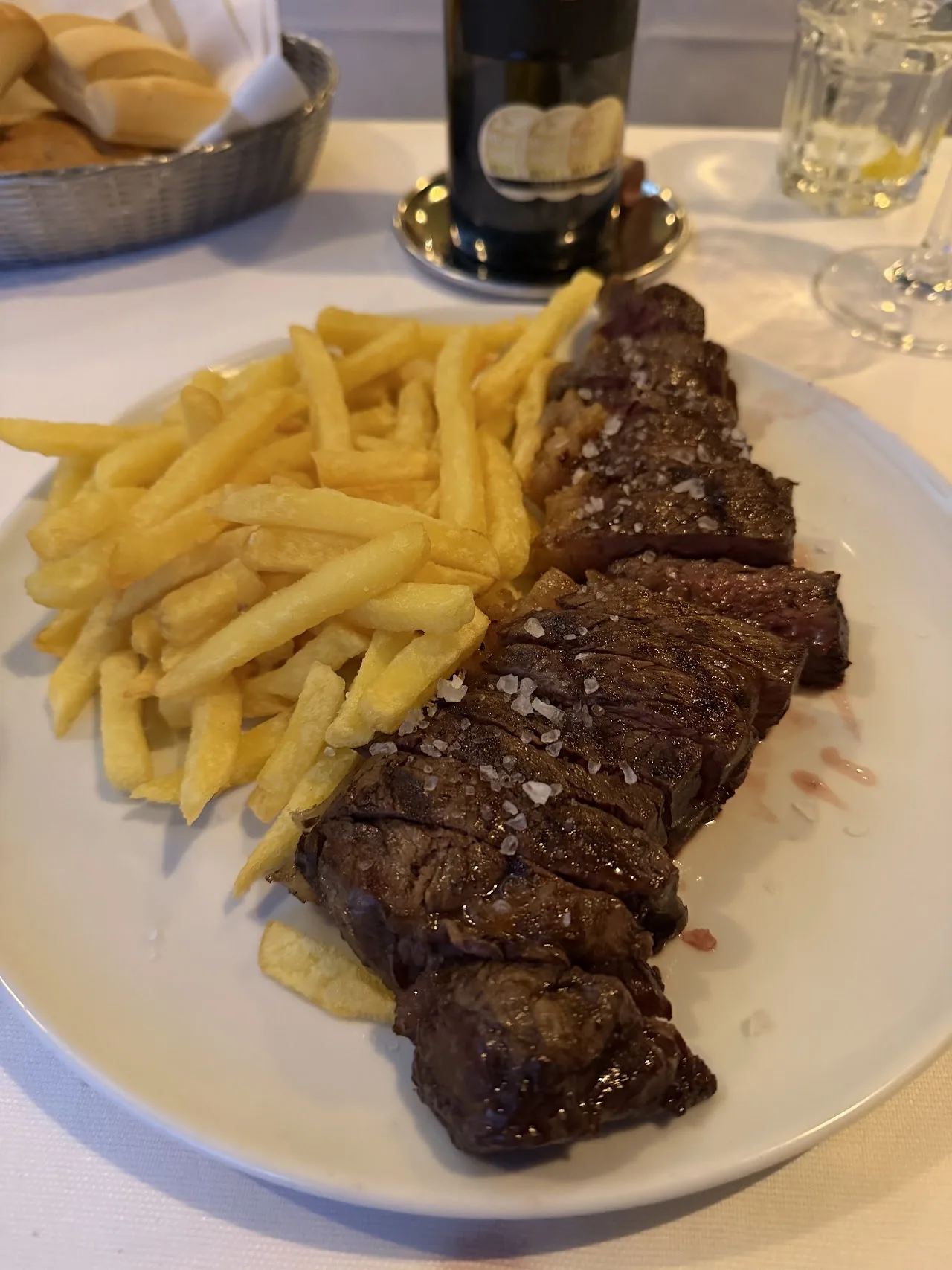 A grilled steak with a side of french fries