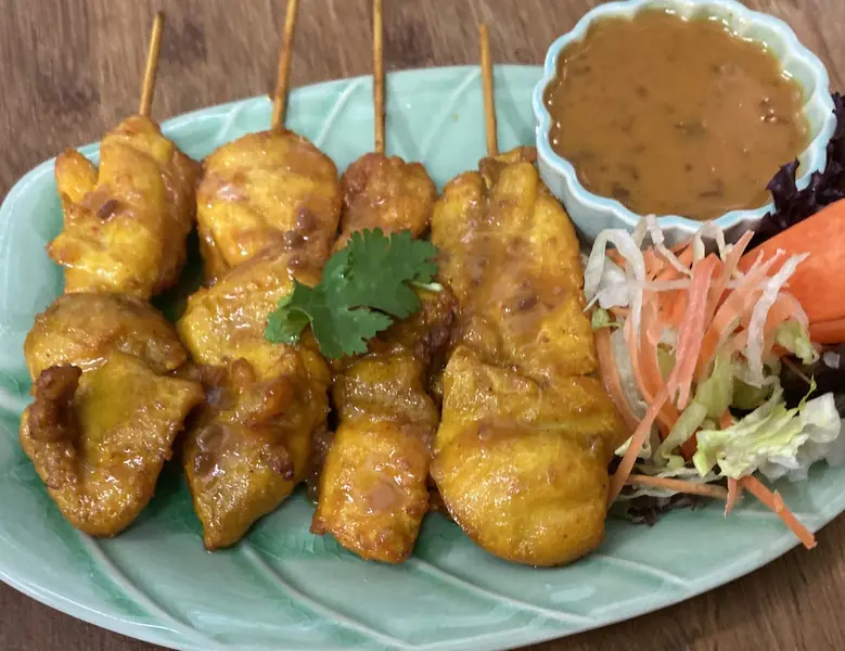 Grilled chicken satay skewers with peanut sauce and a side of shredded carrot and cabbage salad, Thai Zaap