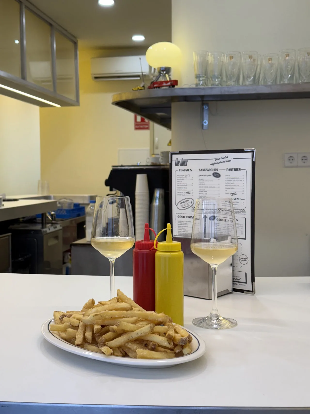 A plate of french fries with ketchup and mustard on the table