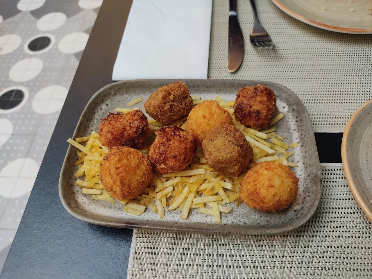 Fried croquettes served with a side of french fries