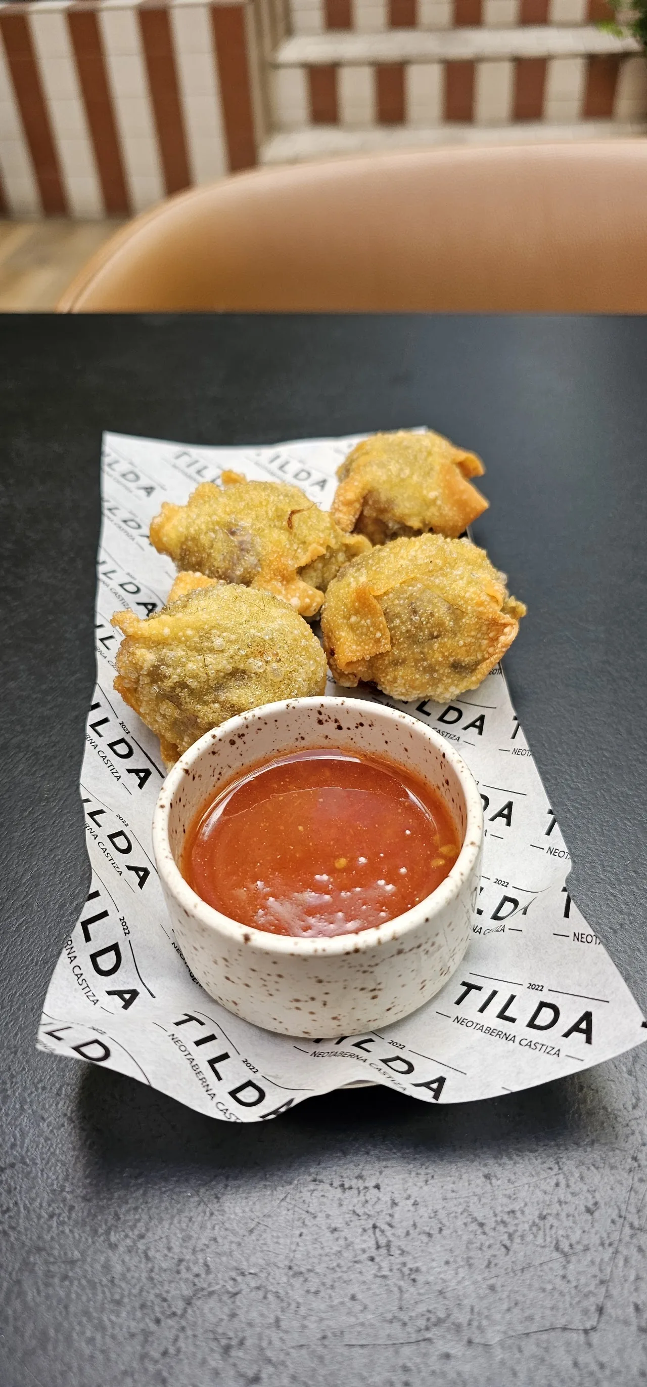 Fried croquette bites with a small bowl of dipping sauce