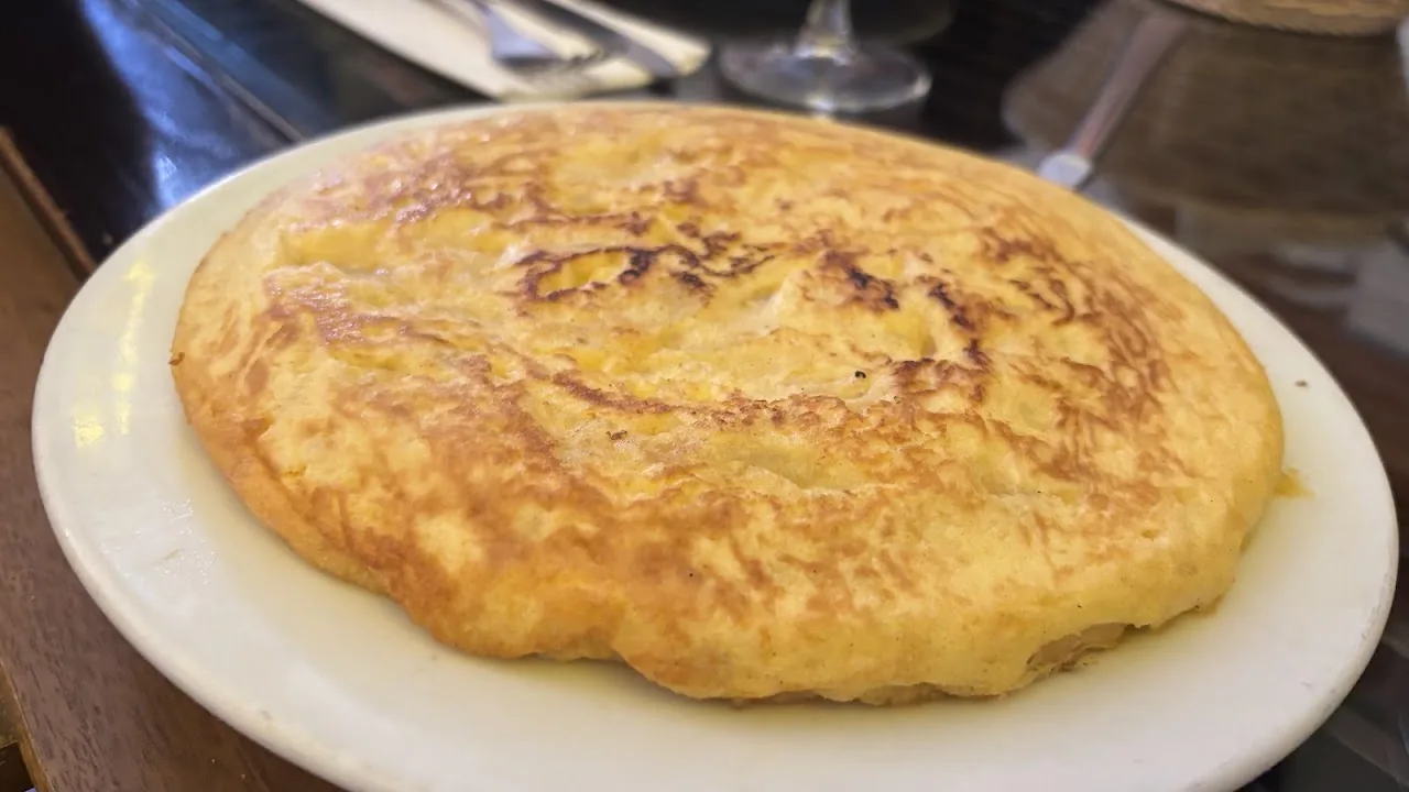 A Spanish potato omelette (tortilla espanola) on a plate