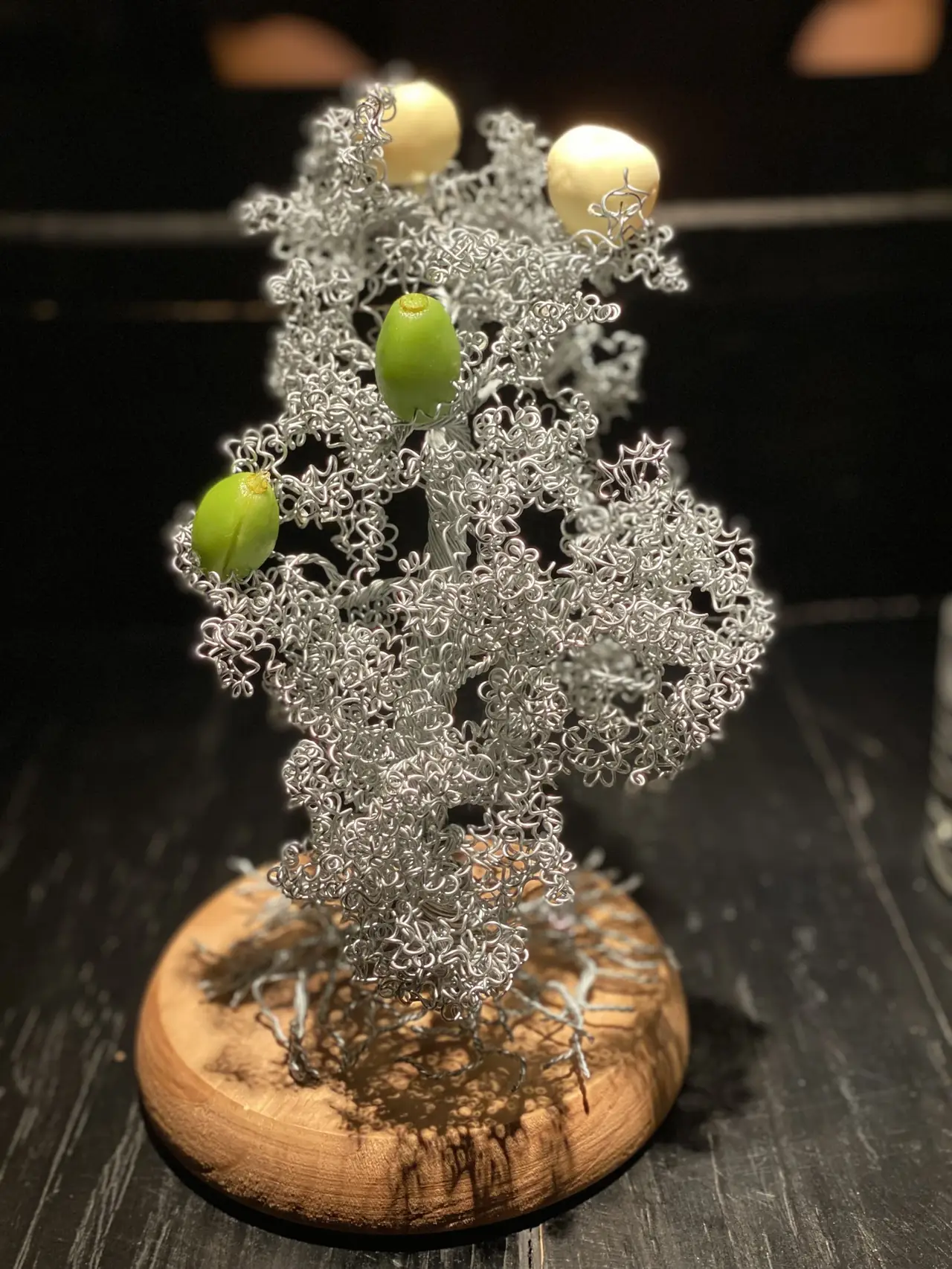 Small bites served mounted on a decorative silver wire tree sculpture