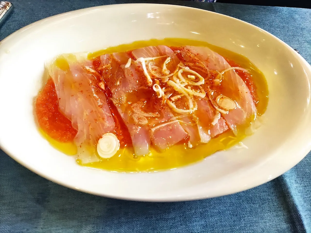 Thin slices of cured meat drizzled with olive oil and garlic