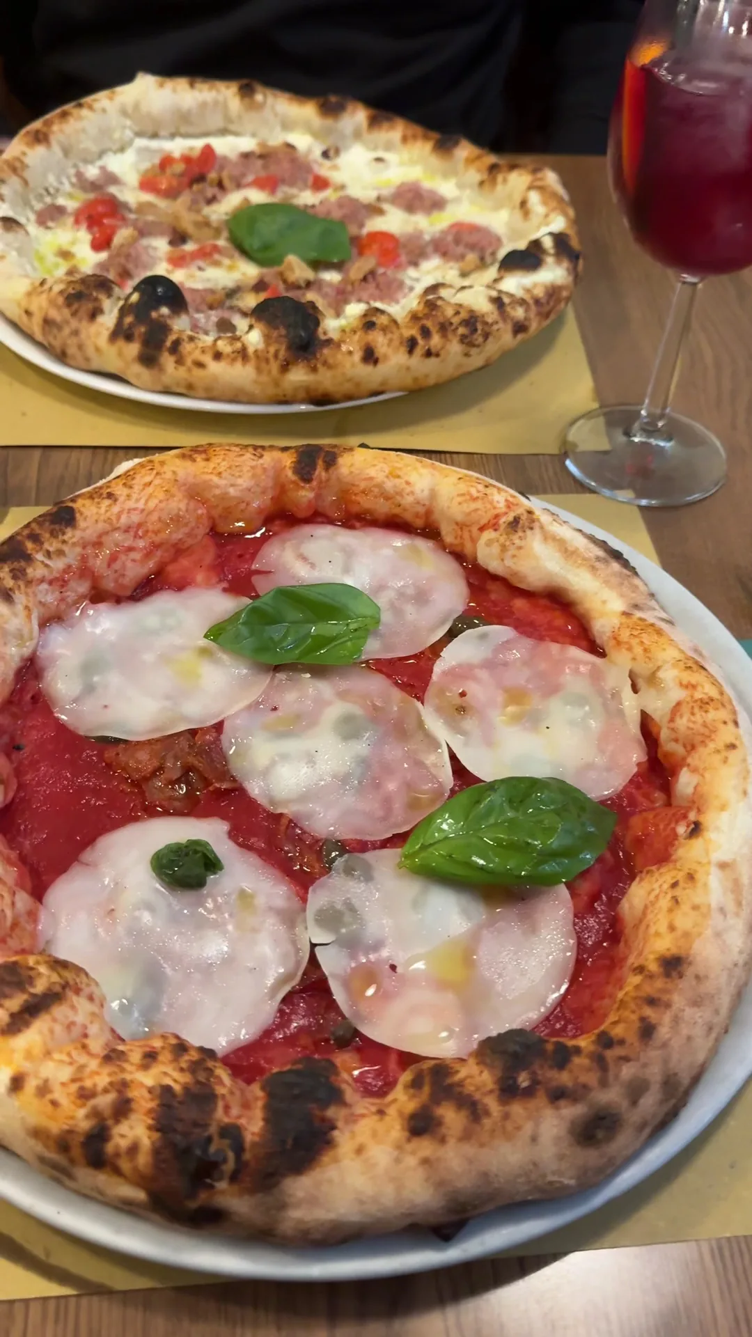 A margherita pizza topped with fresh basil and mozzarella