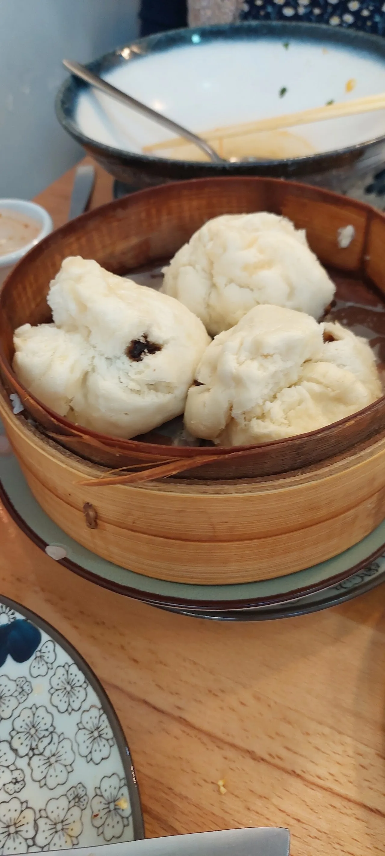 A bamboo steamer basket filled with steamed dumplings