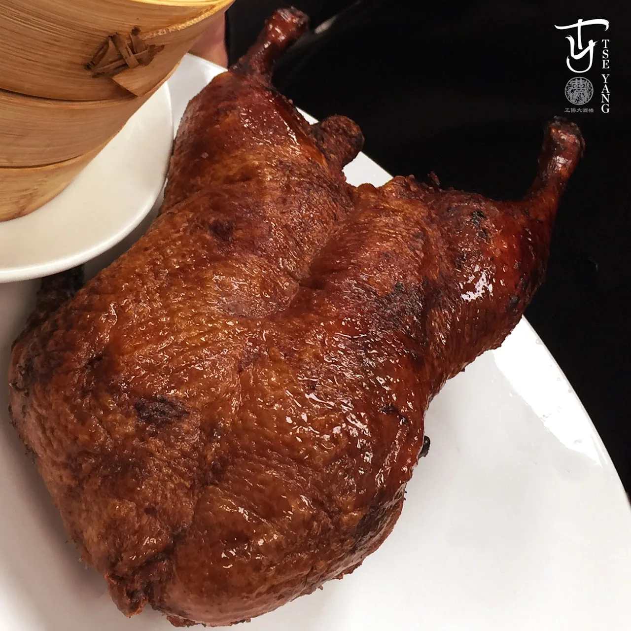 A whole roasted Peking duck on a platter