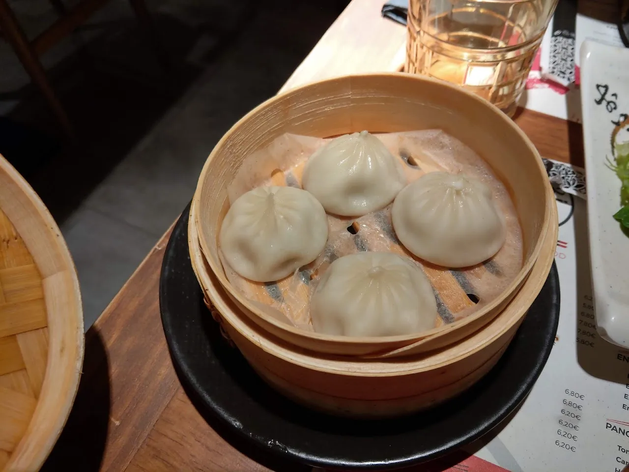 A bamboo steamer of steamed buns (baozi)