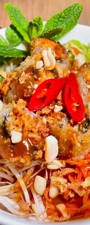 Crispy fried spring rolls over rice vermicelli noodles with bean sprouts, shredded carrot, crushed peanuts, mint, and sliced red chili, Tutu Vietnamese Cuisine