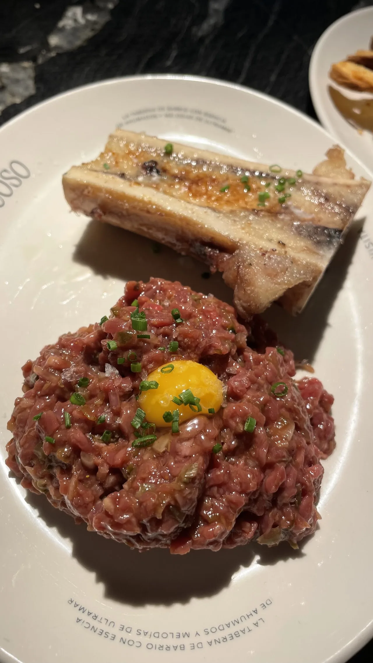 Steak tartare topped with an egg yolk