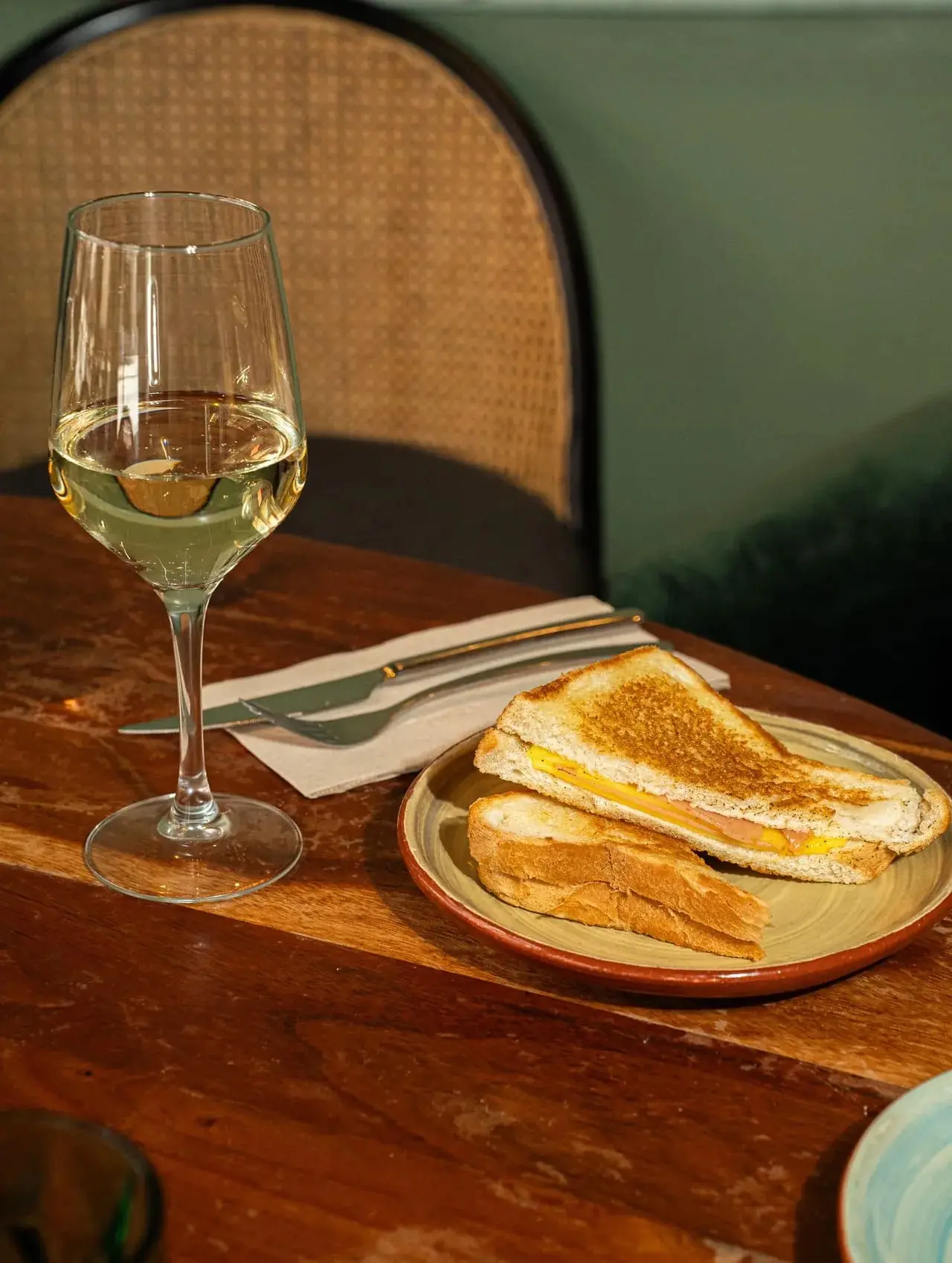 Thinly sliced roasted artichoke petals fanned on a yellow ceramic plate with microgreens, Velada Barcelona
