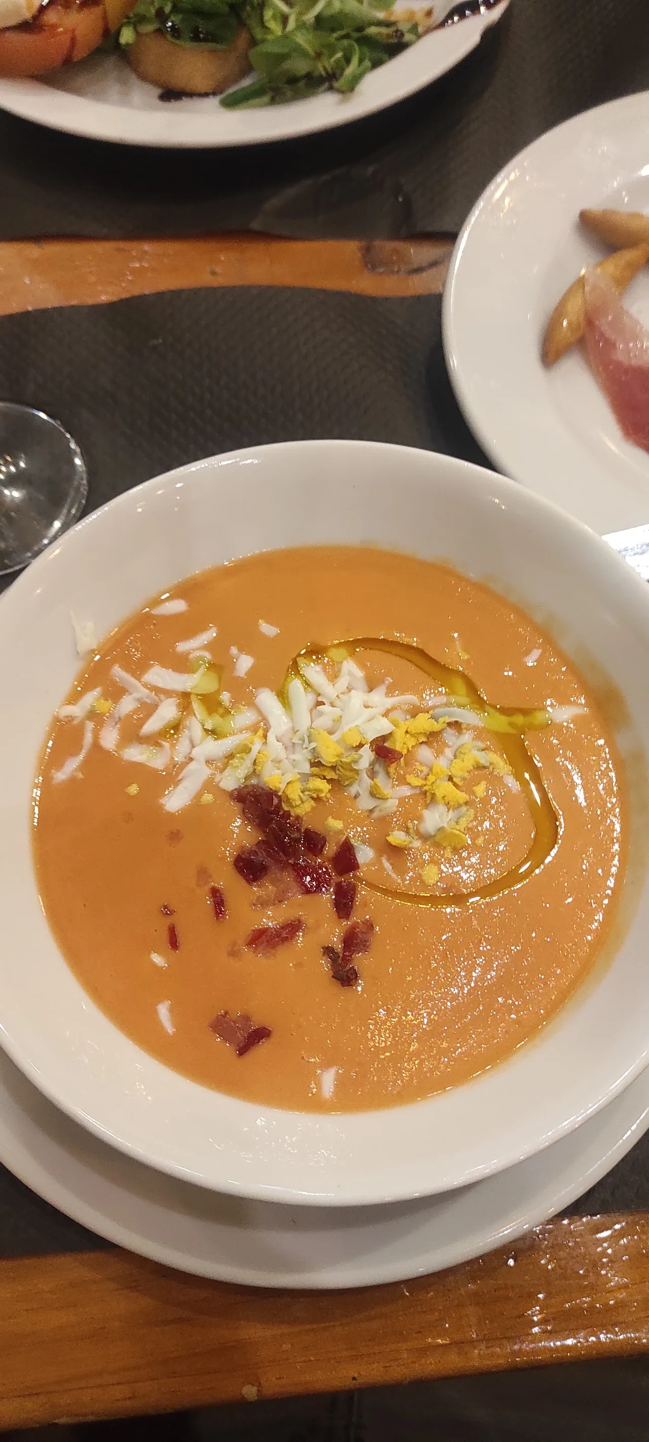 A bowl of gazpacho garnished with herbs