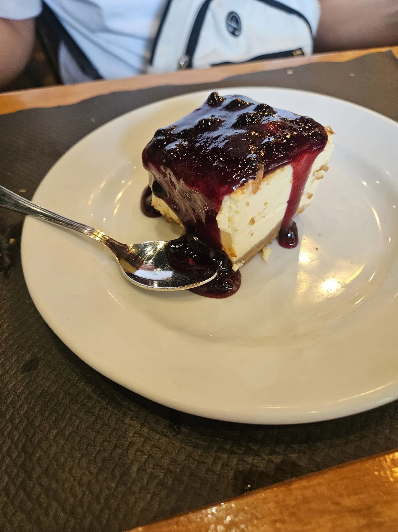 A slice of cheesecake with berry compote