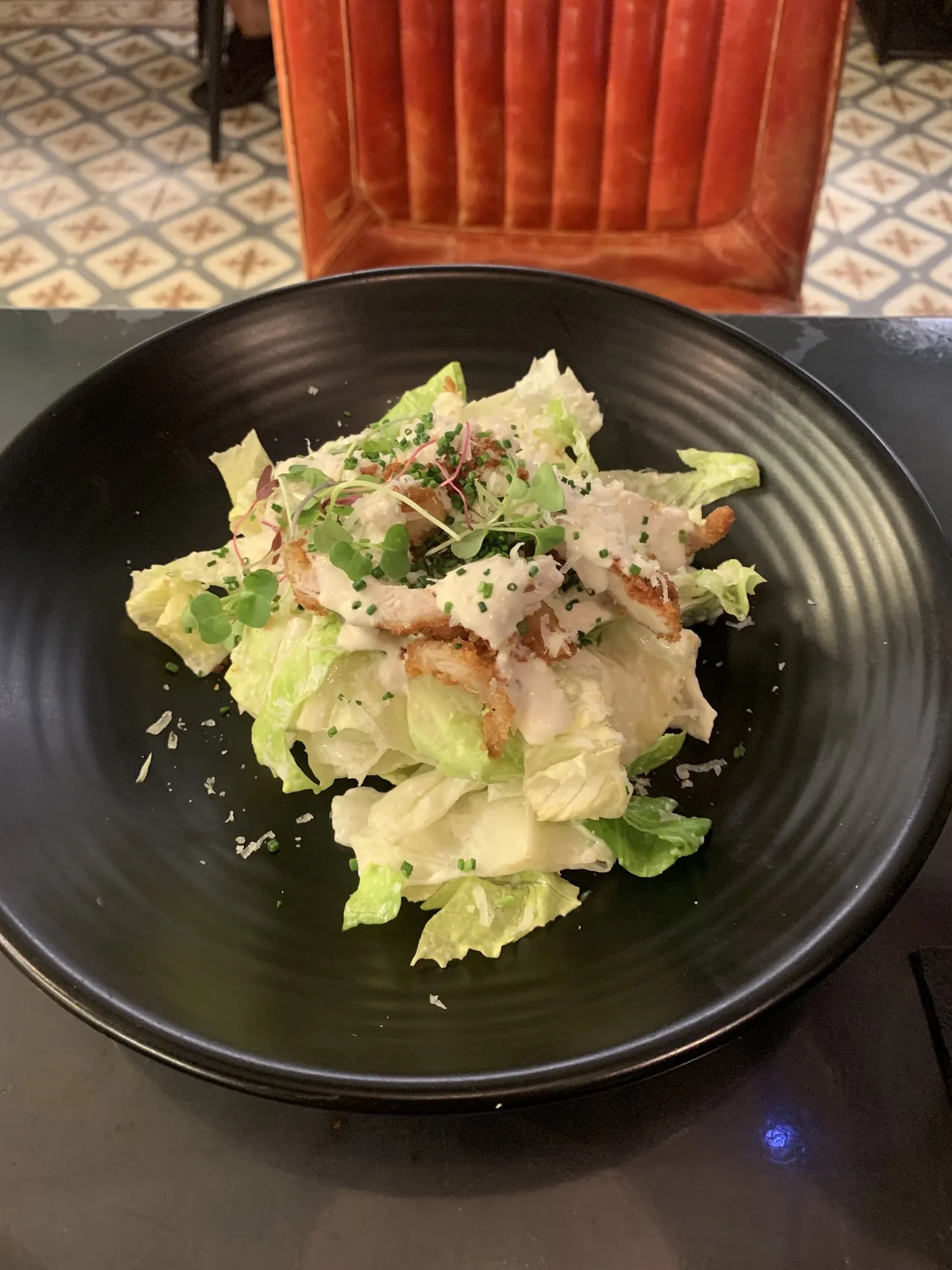 A bowl of lettuce salad with a creamy dressing