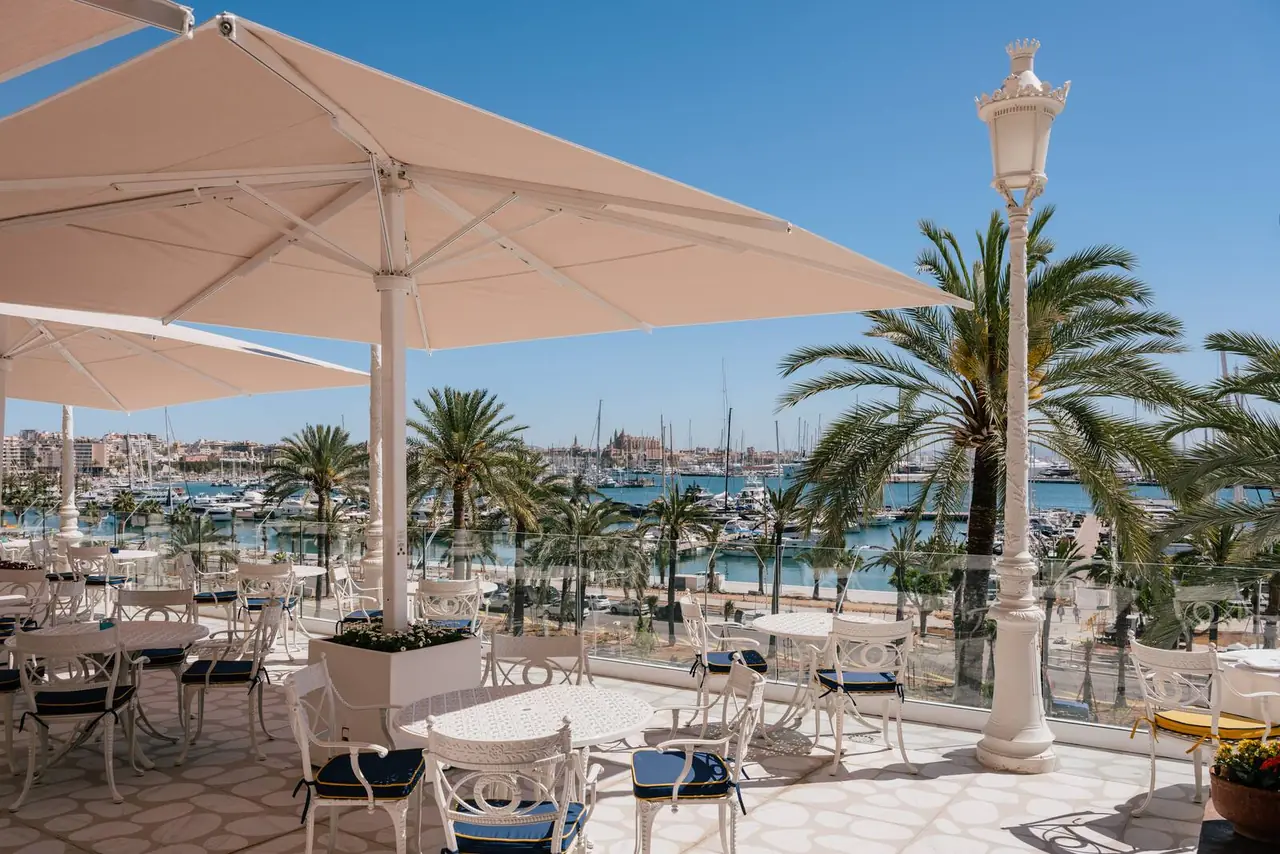 The Victoria Grand Café terrace with parasols over the marina
