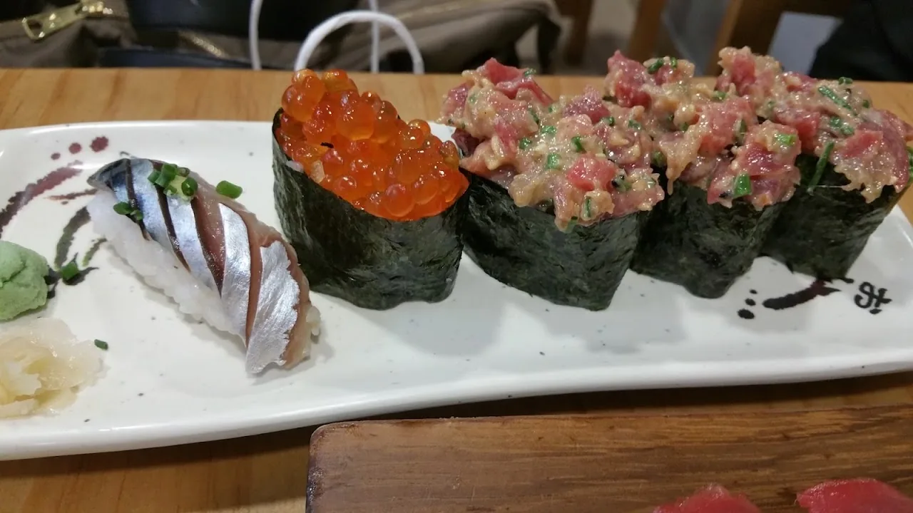 A platter of nigiri and hand rolls with salmon roe