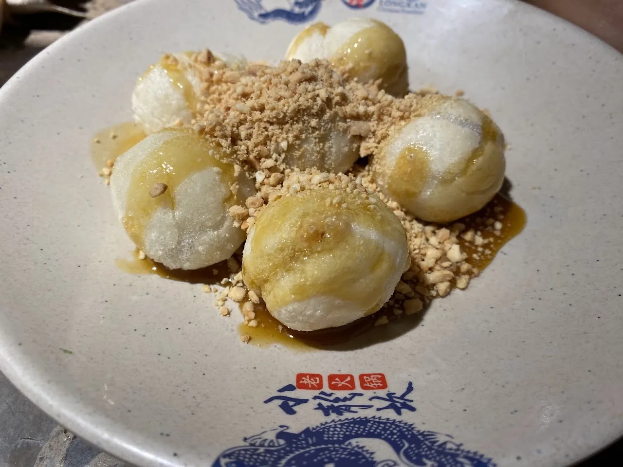 Rice cake balls topped with crushed peanuts and syrup