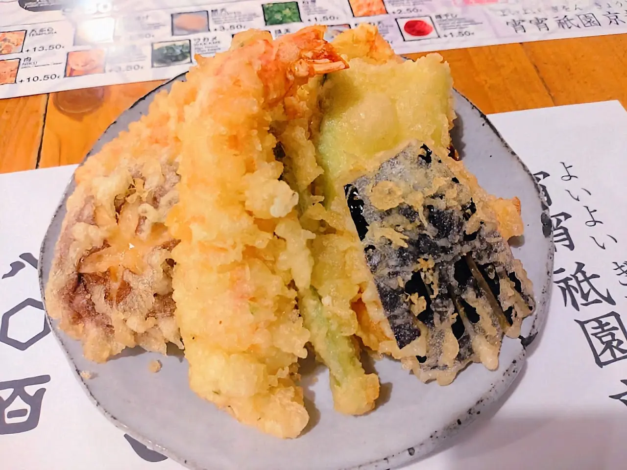 Assorted vegetable and seafood tempura on a plate, at Yoi Yoi Gion.