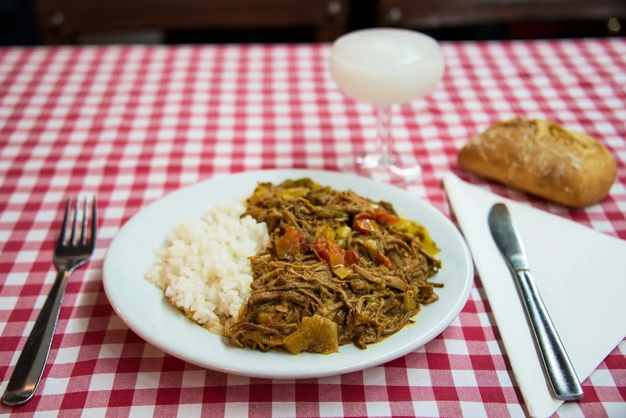 A plate of shredded braised beef with white rice and bread